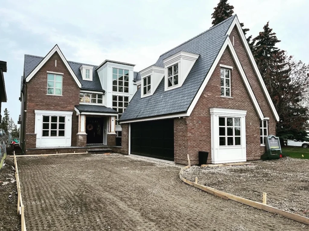 2023 custom home exterior brick siding panels half round gutters Rhino Exteriors Calgary contractor