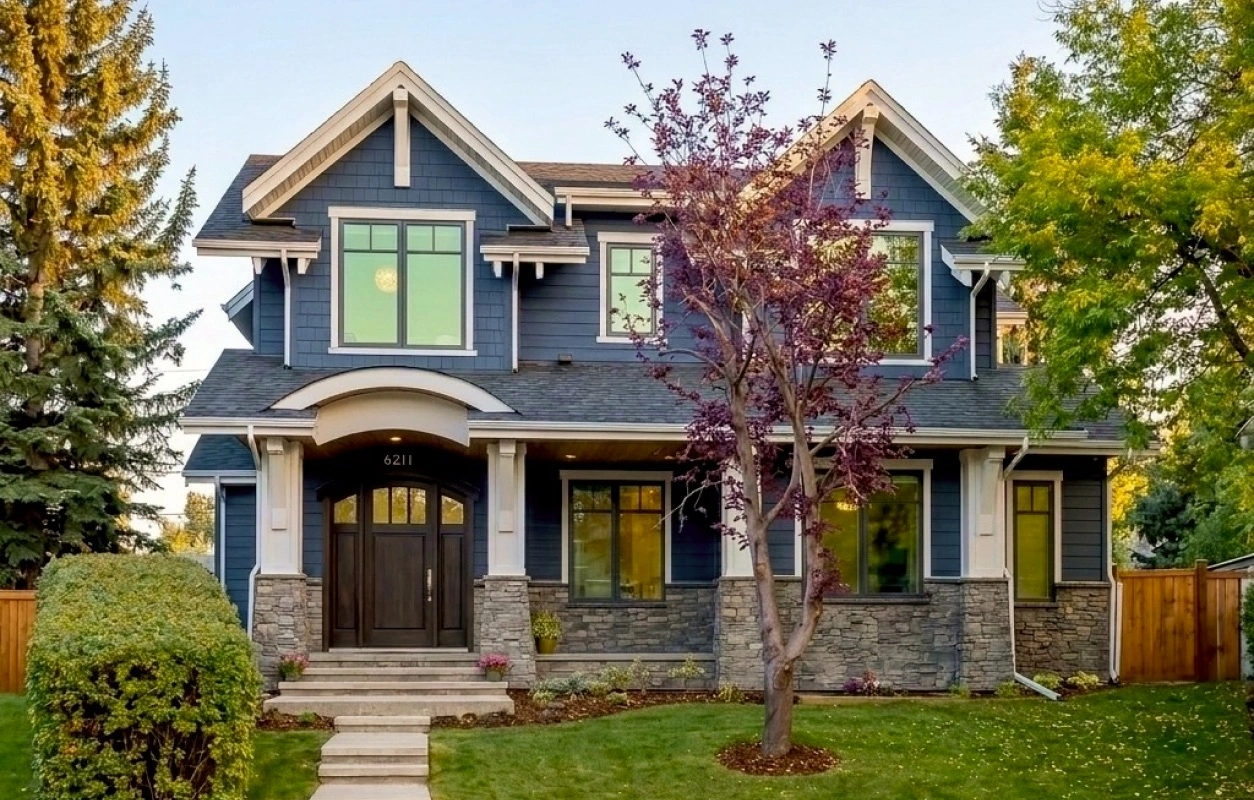 Lakeview Calgary custom home exterior featuring James Hardie® lap siding, Hardie® shake accents, SmartBoard® trim systems, and architectural detailing by Rhino Exteriors