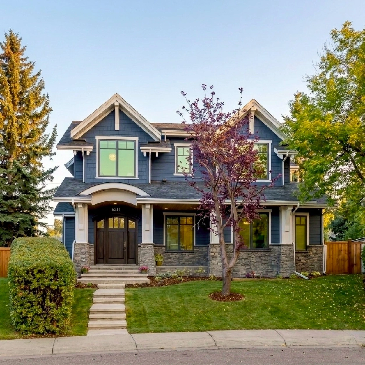 Lakeview Calgary custom home exterior featuring James Hardie® lap siding, Hardie® shake accents, SmartBoard® trim systems, and architectural detailing by Rhino Exteriors